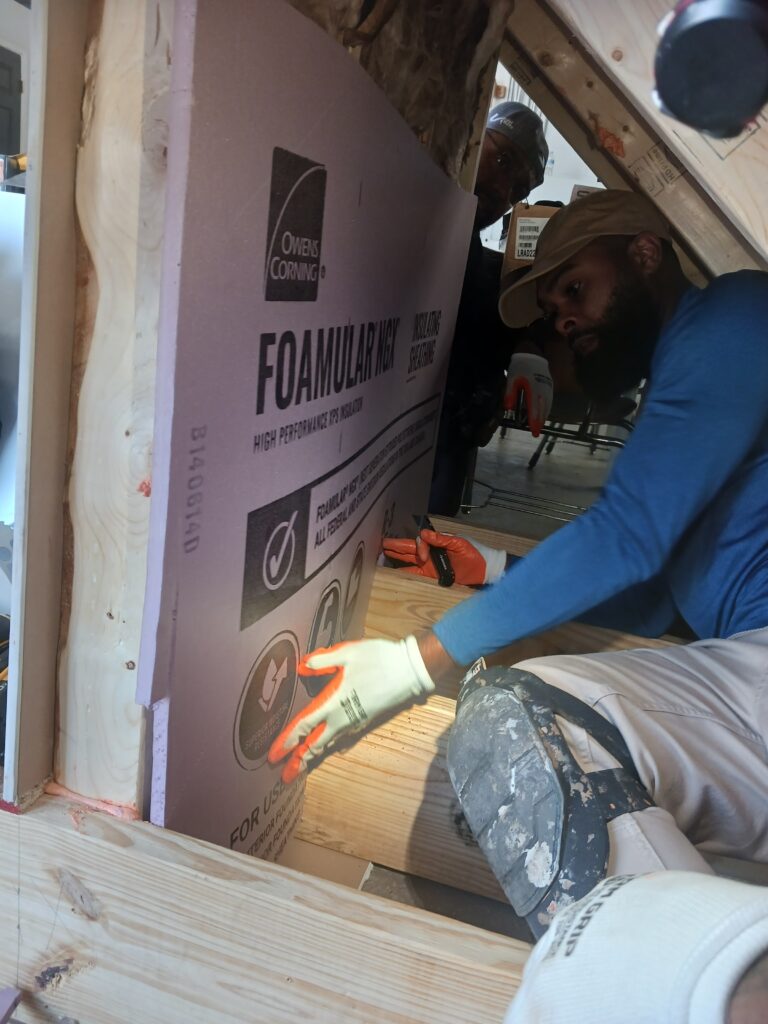 Installing insulation in new construction house